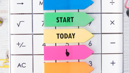 Colorful sticky notes feature the words start and today, arranged on a surface with various...
