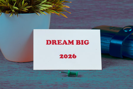 A motivational card stating DREAM BIG sits on a vibrant surface.