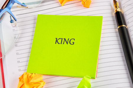 On a vibrant green note, the word king stands out prominently. Nearby, colorful stationery and...