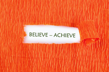 Vivid orange texture serves as a striking backdrop for a passionate message about belief and achievement, inviting viewers to embrace their potential and strive for successの写真素材