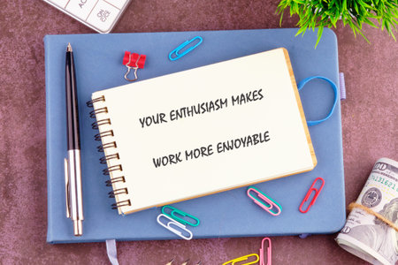 Top-down presentation displays a notebook with an inspiring message, sitting on a blue journal...