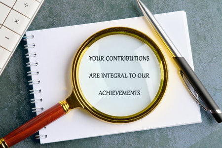 A calculator, notebook, pen, and magnifying glass are neatly arranged, highlighting the importance of individual contributions to collective success and achievements.の写真素材