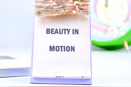 A close-up reveals calendar pages adorned with the empowering message BEAUTY IN MOTION. The calendar...