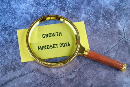 A golden magnifying glass rests on a vibrant yellow note with the words Growth Mindset 2026. The...