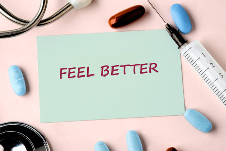 A light green note displaying Feel Better in red sits on a pink background, encircled by a...