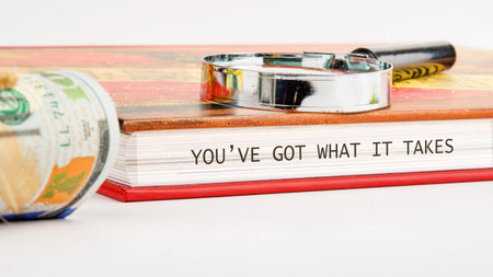 An inspirational phrase displayed on book pages states you have what it takes, alongside United...
