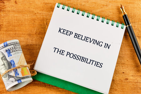 A spiral notepad boldly displays an uplifting message encouraging belief in possibilities.