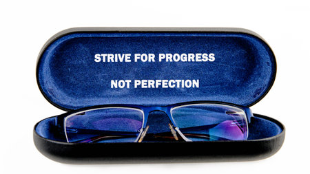 Blue spectacles rest peacefully in a velvet-lined case. Its open lid displays a timeless message:...