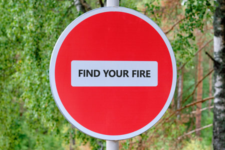 Bright forest: red Find Your Fire sign amid green. Guides introspection.