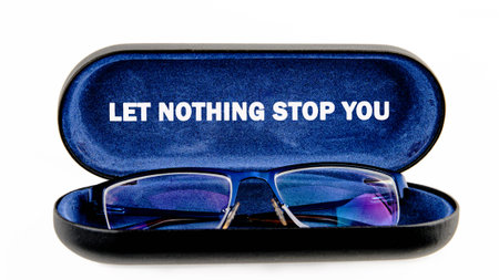 Blue framed spectacles lie open in a deep blue velvet case, revealing the powerful declaration Let...