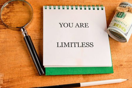 A compelling declaration YOU ARE LIMITLESS illuminates a white notepad, accompanied by a discerning...