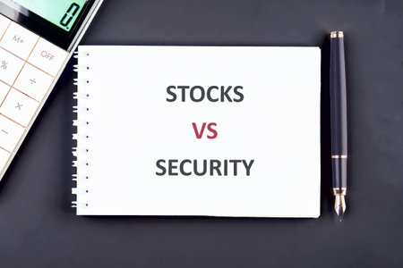 Fundamental investment terms, stocks and security, are contrasted on a crisp white notepad,...