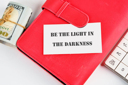 Inspiring wisdom for financial journeys a bold quote rests on a crimson planner alongside a stack of...