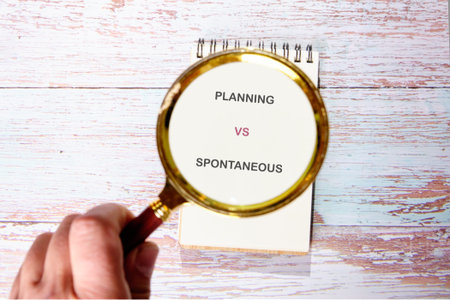 Considering planning vs. spontaneity, a key choice on a notebook atop weathered wood.