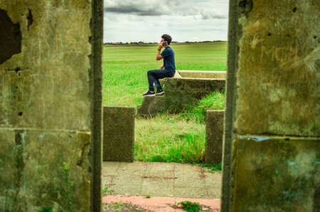 Man calling by cell phone, young man in the field calling by cell phoneの写真素材
