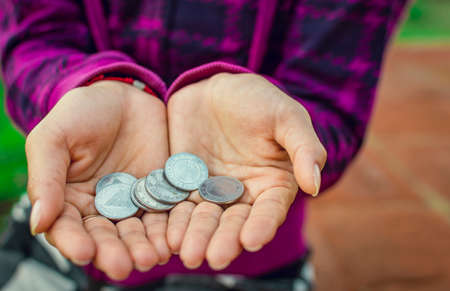 Close up of coins in hands, Nicaraguan coins in hands, savings conceptの写真素材
