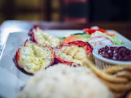 Plate of breaded shrimp with rice on the table with COPY SPACE, menu of breaded shrimp served on wooden tableの写真素材