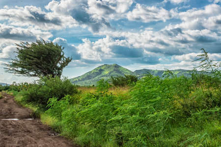 A road near a volcano, road next to a volcano with blue sky and clouds with copy space, volcanoes of nicaraguaの写真素材