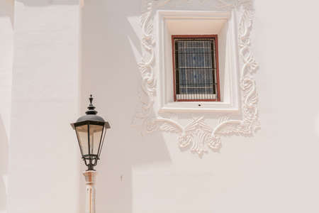 Lantern poles with copy space, an illuminated lantern pole next to a window, public lantern poleの写真素材