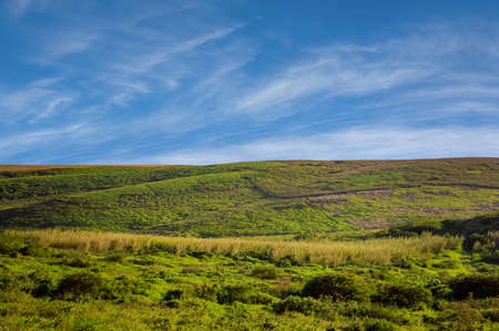 picture of a hill with clouds and blue sky, picture of a hill with blue sky in the background