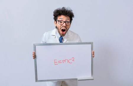 Scientist holds and points to a whiteboard with a mathematical formula. Scientist showing blackboard with mathematical equation, Physics professor holding whiteboard with a mathematical formulaの写真素材