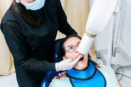 Female dentist doing dental x-ray, Female dentist doing x-ray to patient, female dentist doing dental x-ray, dental x-ray conceptの写真素材