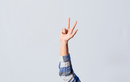 Number THREE in sign language. Fingers counting the number THREE in sign language, Fingers of people counting number THREE in sign language. Concept of numbers in sign languageの写真素材