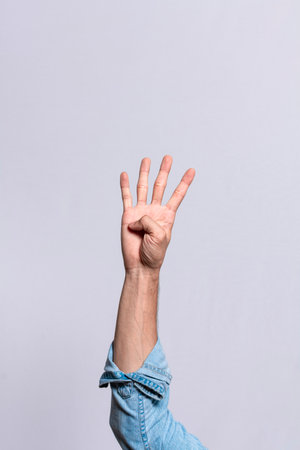 Hand counting number four, Man hand showing number four, Guy finger counting number four on isolated backgroundの写真素材