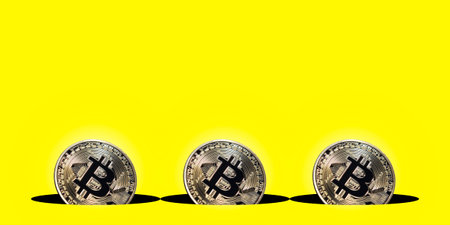 Virtual cryptocurrency concept, bitcoin gold coin on yellow background with copy space, bitcoin gold...