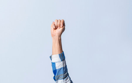 Hand gesturing the letter M in sign language on an isolated background. Man's hand gesturing the letter M of the alphabet isolated. Letter M of the alphabet in sign languageの写真素材