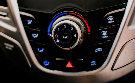 Front view of a car air conditioning control panel. Air conditioning knob of a car. Close up of automotive air conditioning switch panelの写真素材