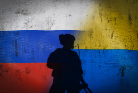 Russia vs Ukraine flag on cracked wall, concept of war between russia and ukraine, silhouette of...