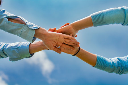 Concept of one hand over another forming a team, Concept of unity with the hands, palms together all...