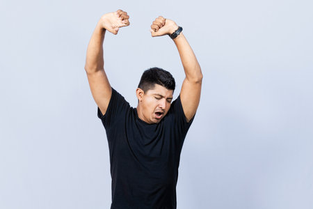 People yawning and stretching his hands, sleepy man stretching his hands isolated, concept of a sleepy exhausted manの写真素材