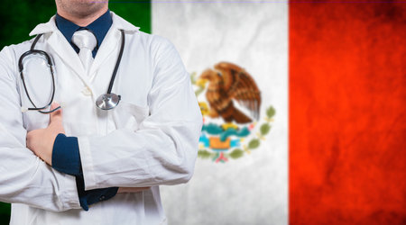 Doctor with arms crossed on Mexico flag background. Doctor with stethoscope on Mexico flag. Medical health and care on Mexican flagの写真素材