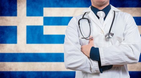 Doctor with stethoscope on greece flag. Doctor with crossed arms on greece flag, Health and care with flag of greeceの写真素材