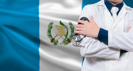 Doctor with stethoscope on guatemalan flag. Doctor arms crossed with stethoscope on Guatemalan flag, Guatemala national health conceptの写真素材