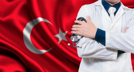 Doctor with stethoscope on Turkish flag. Doctor with crossed arms on Turkish flag, Turkish national health conceptの写真素材