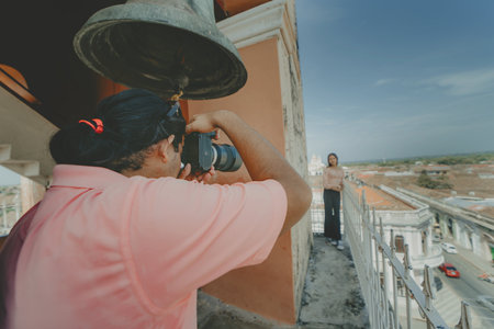 Tourists taking photographs at the viewpoint of the La Merced church, Granada. Tourist couple taking pictures at the viewpoint of the La Merced churchの写真素材