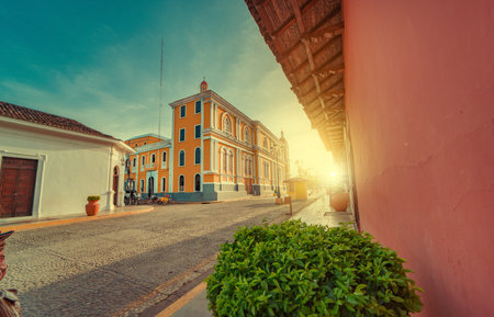 View of the street of the cathedral of Granada Nicaragua leading to La Calzada at sunsetの写真素材