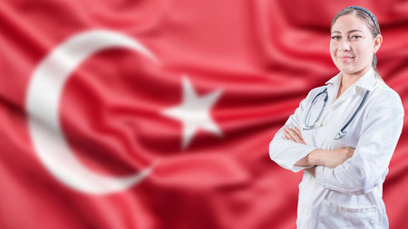Portrait of doctor with crossed arms with Turkish flag in the background. Healthcare concept with Turkish flag in backgroundの写真素材