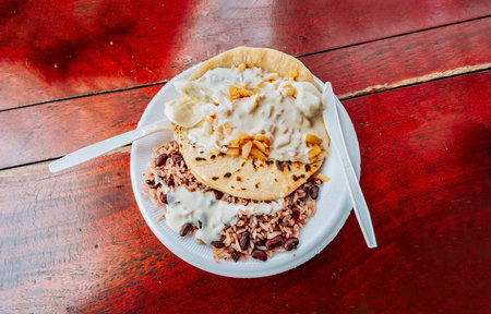 Gallopinto with Quesillo served on wooden table. Top view of traditional Gallopinto with quesillo on the table. typical nicaraguan foodsの写真素材