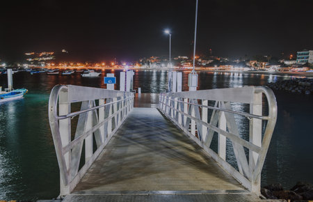 Night view of the San Juan del Sur pier, Nicaragua. Night view of a pier surrounded by boatsの写真素材