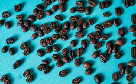 Roasted coffee bulks isolated. Roasted coffee beans on light blue backgroundの写真素材