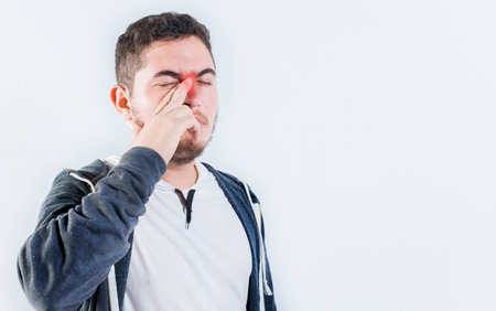 Person with sinusitis and nasal inflammation. Man with nasal congestion isolatedの写真素材