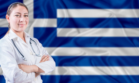 Female doctor on Greece flag. Doctor with crossed arms on Greece flag. Greece Health and Care conceptの写真素材