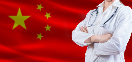 Doctor with crossed arms on China flag. China Health and Care concept. Female doctor on China flagの写真素材