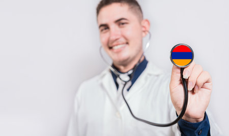 Doctor showing stethoscope with Armenia flag. Armenia national healthcare conceptの写真素材
