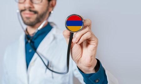 Doctor holding stethoscope with Armenia flag. Armenia health and care concept, Armenia flag on stethoscopeの写真素材