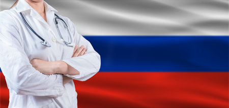 Doctor With Crossed Arms On Russian Flag. Russia Health And Care Concept. Female Doctor On Russian Flagの写真素材